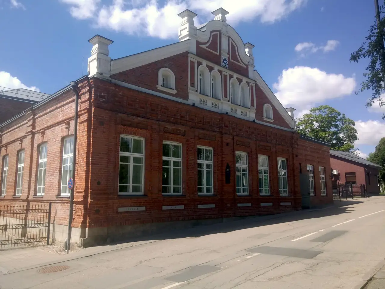 Raudonų plytų Telšių ješivos pastatas su pakopiniu frontonu ir Dovydo žvaigžde gatvės pusėje